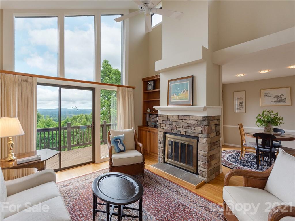 143 Country Ridge Road Hendersonville, NC 28739 - Photo 6 of 29 a living room with furniture a large window and a fireplace