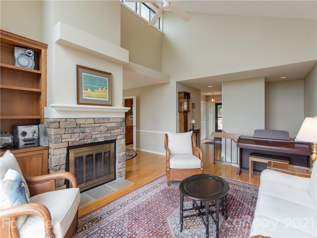 143 Country Ridge Road Hendersonville, NC 28739 - Photo 8 of 29 a living room with furniture a rug and a fireplace