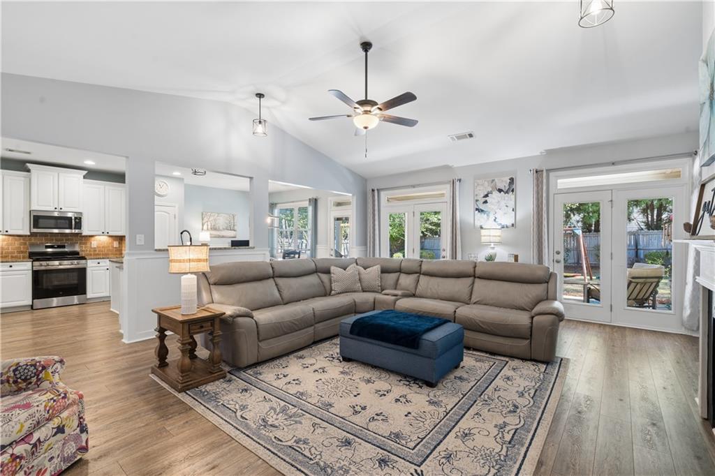 2467 Allsborough Way Dacula, GA 30019 - Photo 11 of 45 a living room with furniture kitchen view and a wooden floor