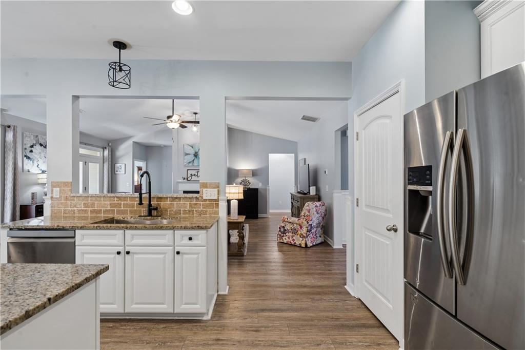 2467 Allsborough Way Dacula, GA 30019 - Photo 22 of 45 a kitchen with stainless steel appliances granite countertop a refrigerator and a sink