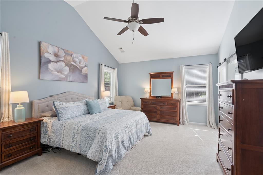 2467 Allsborough Way Dacula, GA 30019 - Photo 23 of 45 a spacious bedroom with a bed and a flat screen tv