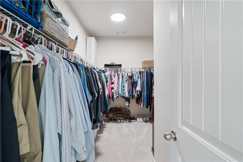 2467 Allsborough Way Dacula, GA 30019 - Photo 26 of 45 a view of walk in closet with clothes