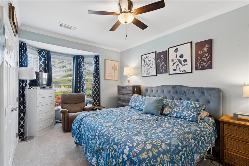 2467 Allsborough Way Dacula, GA 30019 - Photo 34 of 45 a bedroom with a bed and glass windows