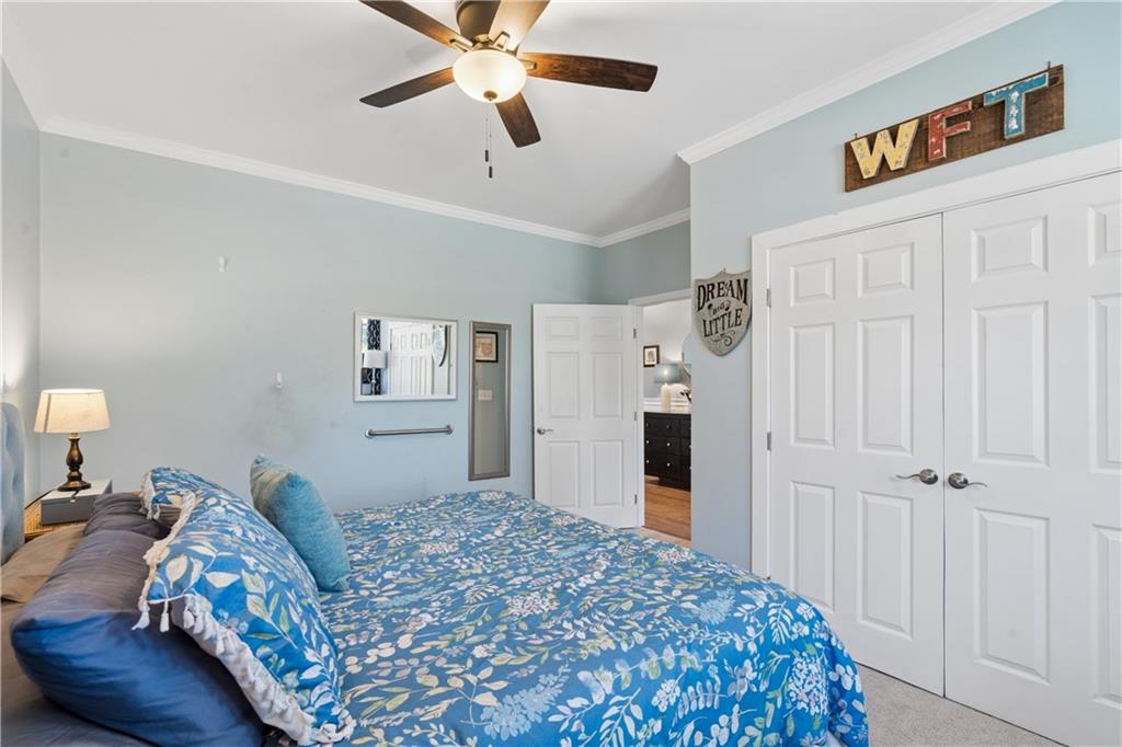 2467 Allsborough Way Dacula, GA 30019 - Photo 35 of 45 a bedroom with a bed and a chandelier