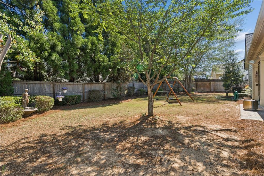 2467 Allsborough Way Dacula, GA 30019 - Photo 38 of 45 a backyard of a house with table and chairs