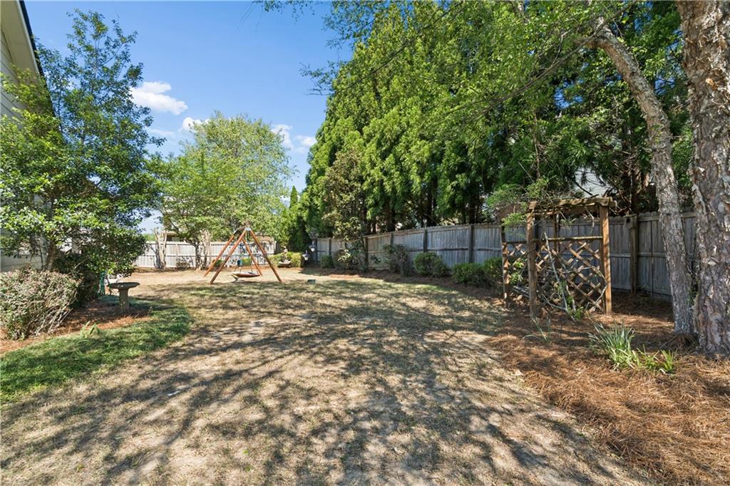 2467 Allsborough Way Dacula, GA 30019 - Photo 39 of 45 a view of a yard with plants and large trees