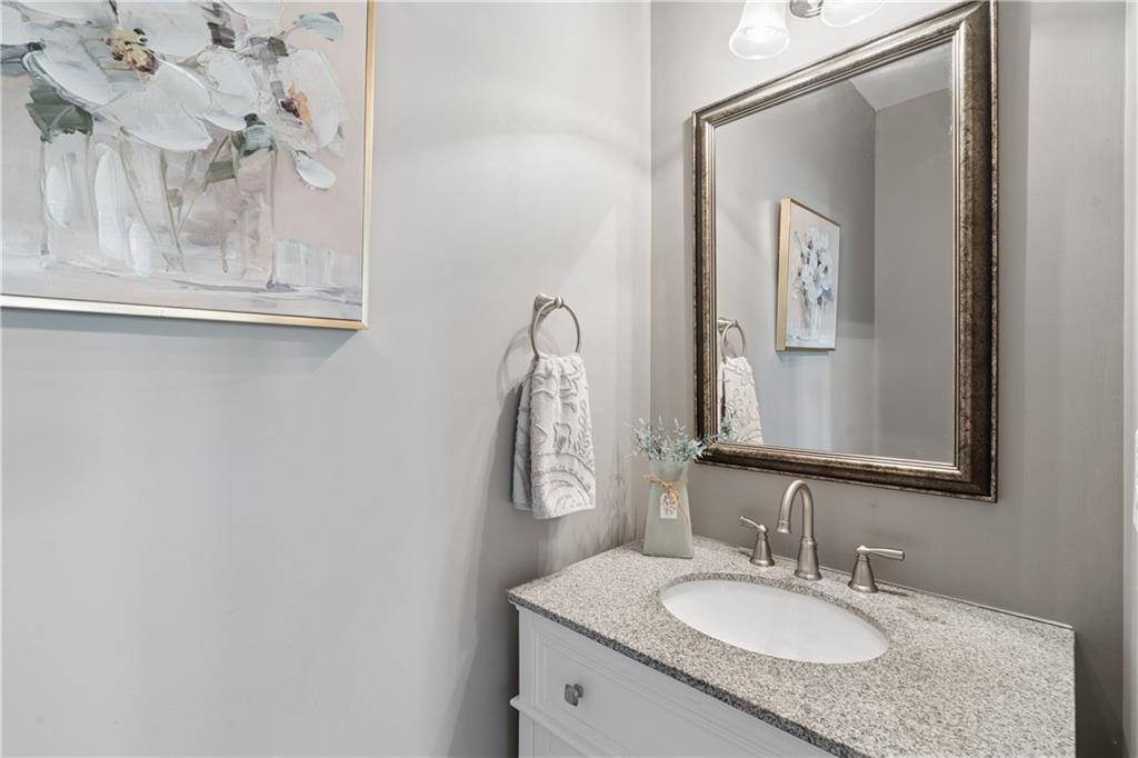 2467 Allsborough Way Dacula, GA 30019 - Photo 9 of 45 a bathroom with a granite countertop sink and a mirror