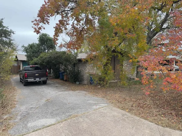 a view of a house with a truck parked in a yard