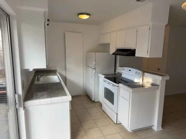 a kitchen with a stove and a refrigerator