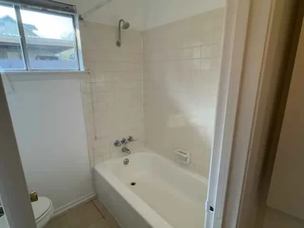 a bathroom with a bathtub and shower