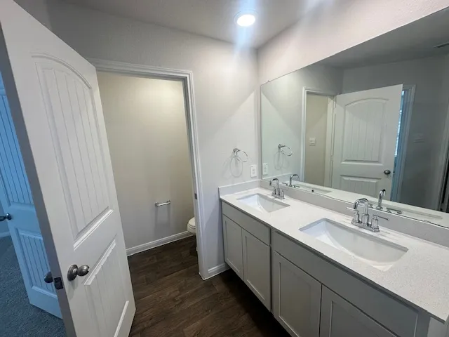 a bathroom with a double vanity sink and mirror