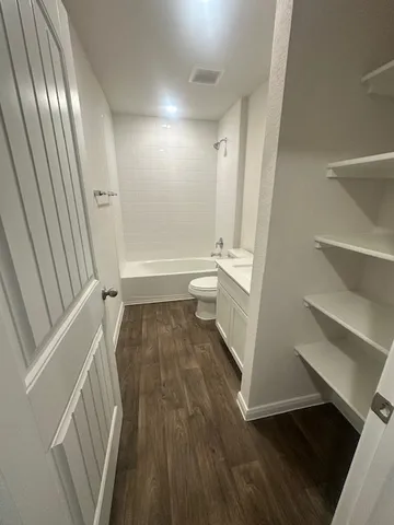 a bathroom with a sink a toilet and a shower
