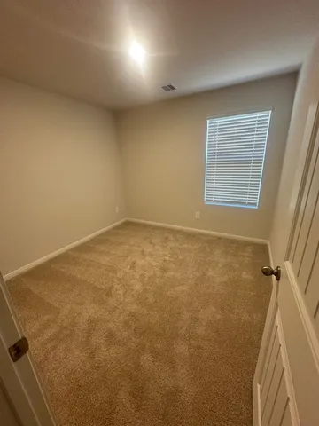 an empty room with a windows