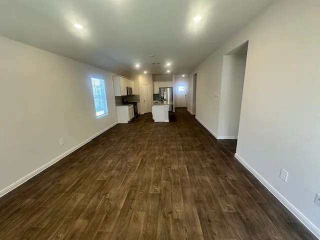 a view of a room with wooden floor