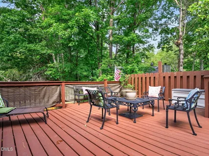a view of deck with table and chairs and wooden floor