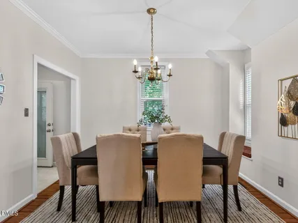 a view of a dining room with furniture and chandelier