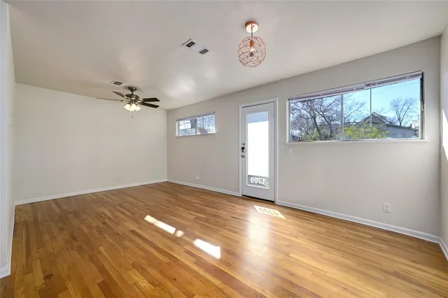wooden floor in an empty room with a window