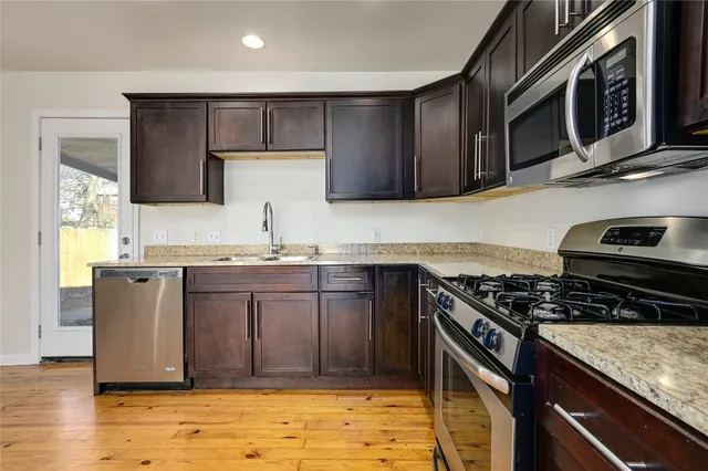 a kitchen with granite countertop a stove and a sink