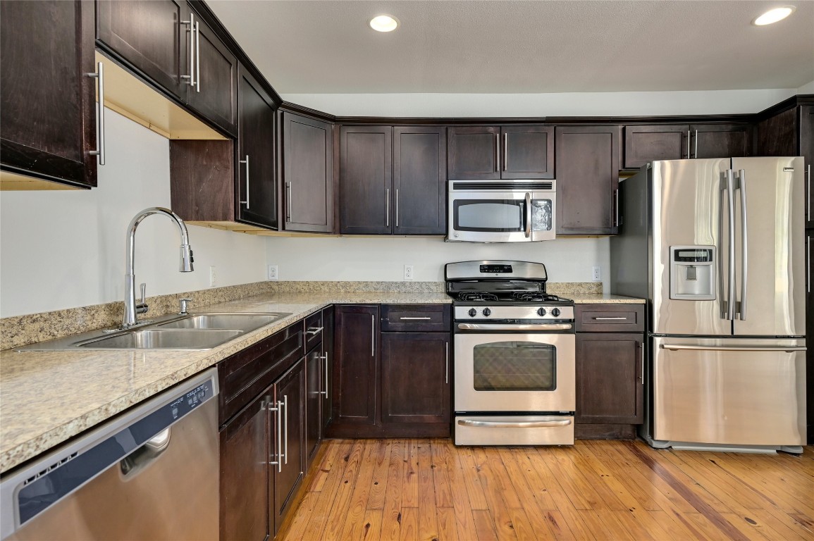 1709 Ulit Avenue Austin, TX 78702 - Photo 7 of 20 a kitchen with granite countertop a sink stove and refrigerator
