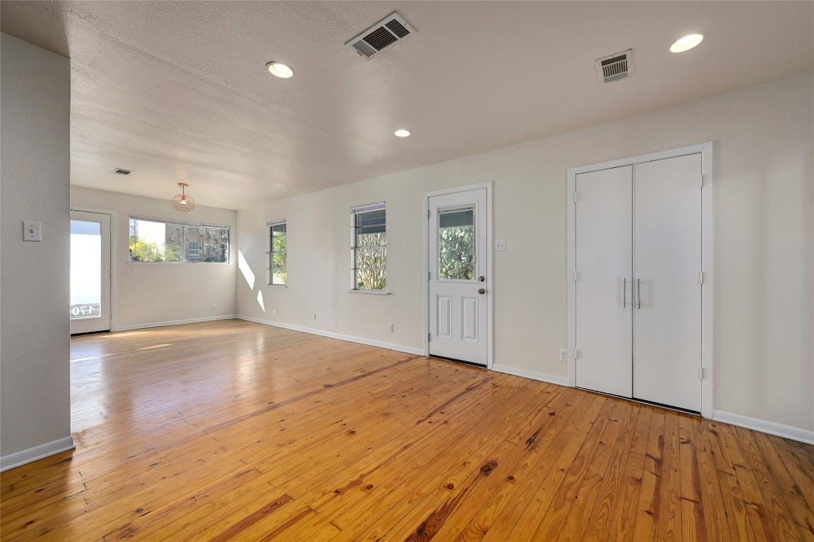 1709 Ulit Avenue Austin, TX 78702 - Photo 8 of 20 a view of empty room with wooden floor and windows