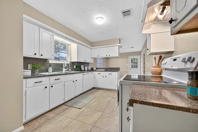 a kitchen with cabinets and window