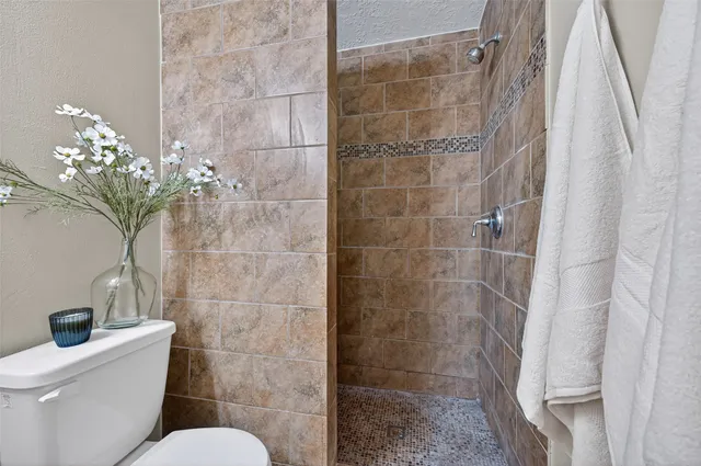 a bathroom with a toilet and shower