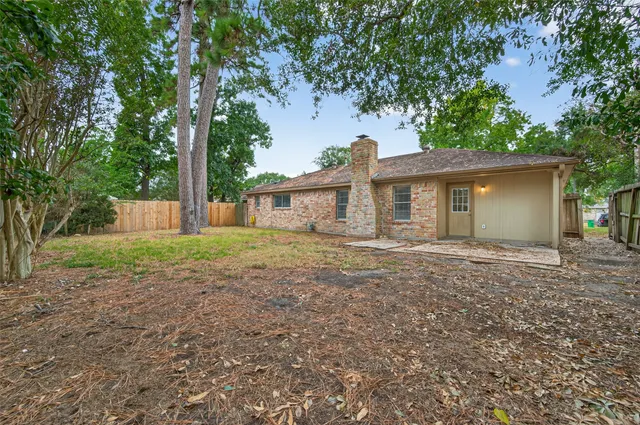 a view of a house with yard and a tree