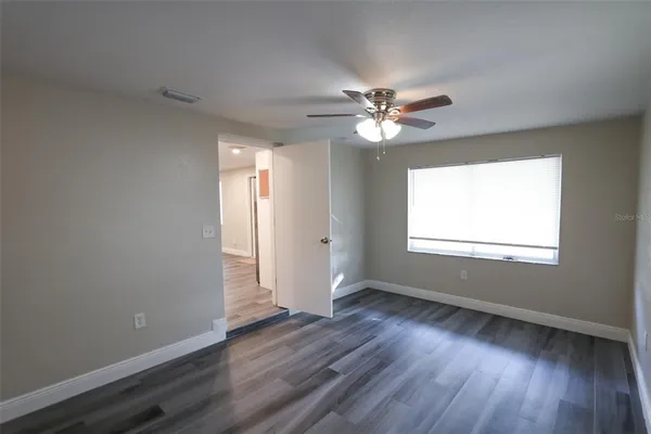 wooden floor in an empty room with a window
