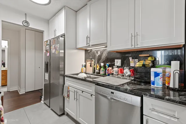 a kitchen with stainless steel appliances granite countertop a refrigerator and a sink