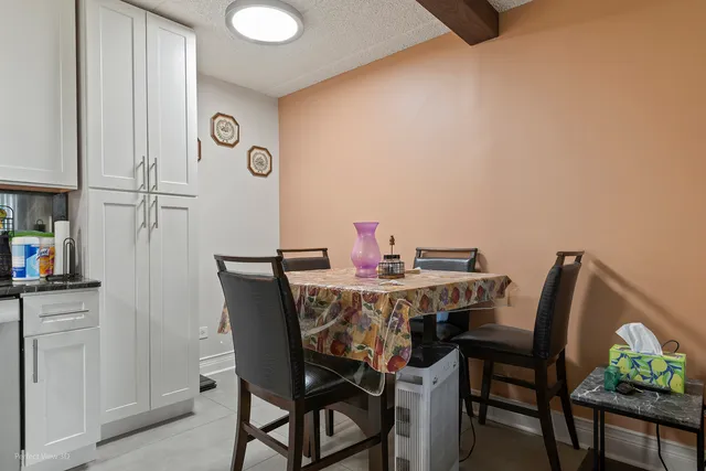 a view of a dining room with furniture and a potted plant