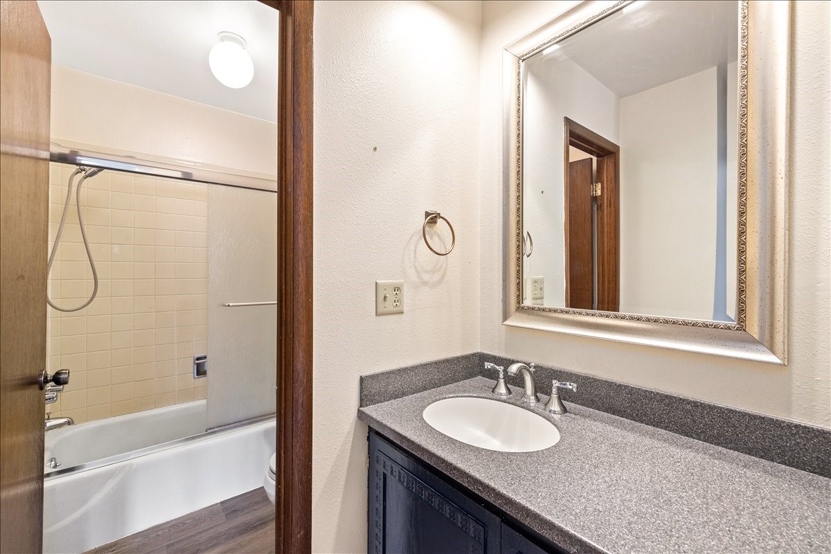 110 Evergreen Road, Unit 301 Dillon, CO 80435 - Photo 13 of 23 a bathroom with a granite countertop sink a mirror and a bathtub