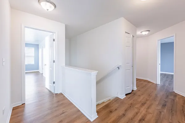 a view of a hallway with wooden floor