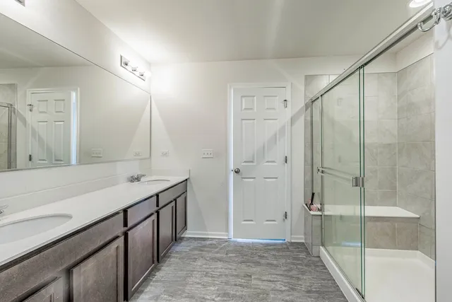 a bathroom with a shower sink and mirror