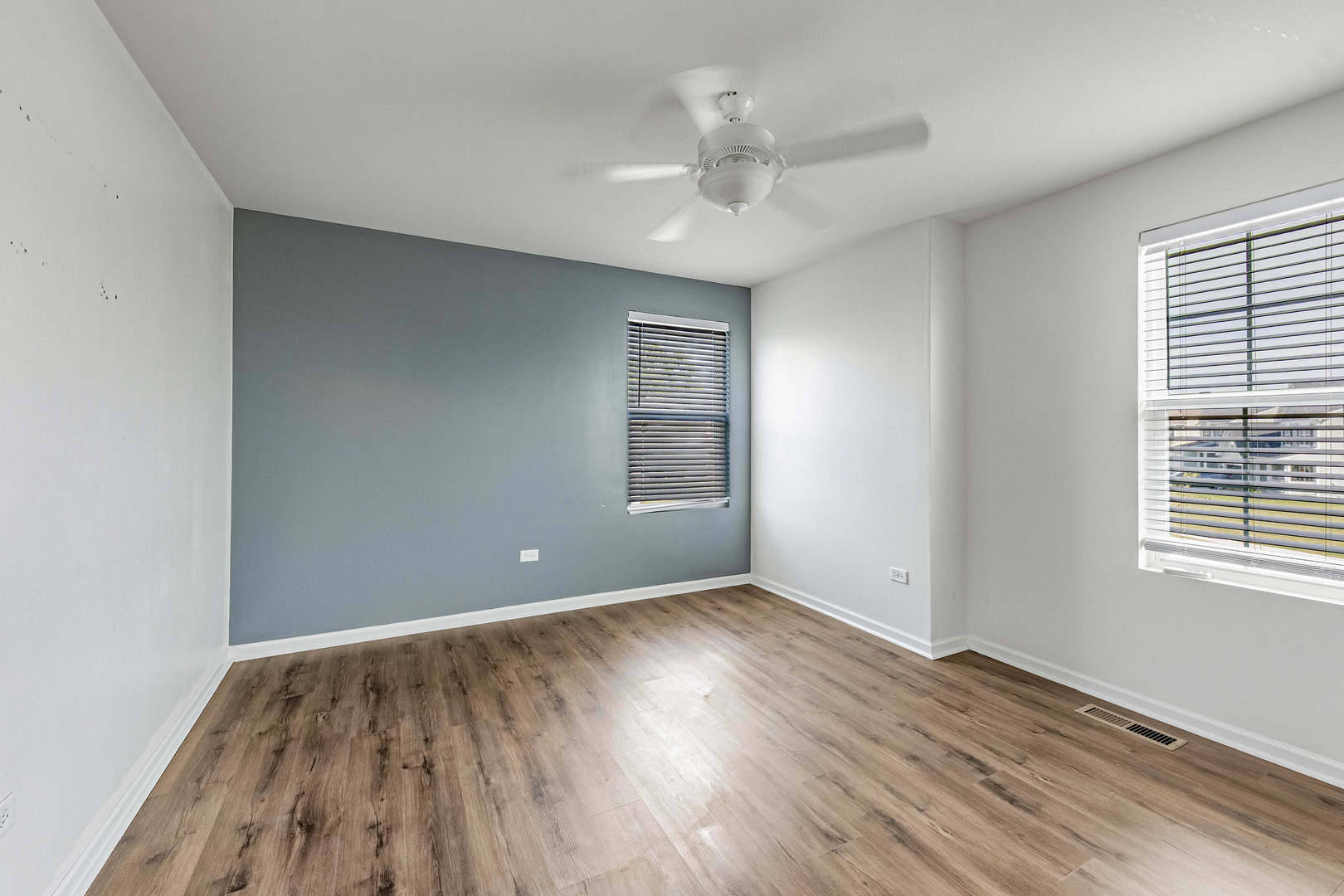 1019 Freeman Street Plano, IL 60545 - Photo 22 of 28 a view of an empty room with wooden floor and a window