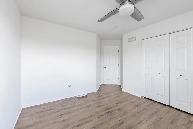 a view of an empty room and wooden floor