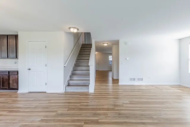 a view of entryway and hall with wooden floor