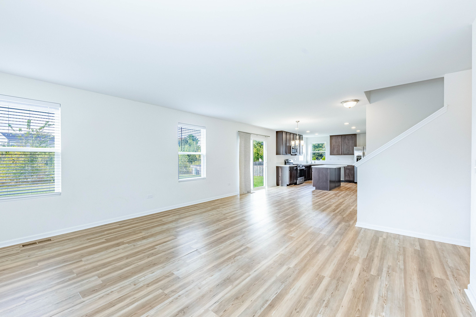 1019 Freeman Street Plano, IL 60545 - Photo 8 of 28 an empty room with wooden floor and windows