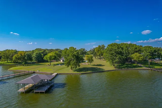 a view of a lake with houses in the back