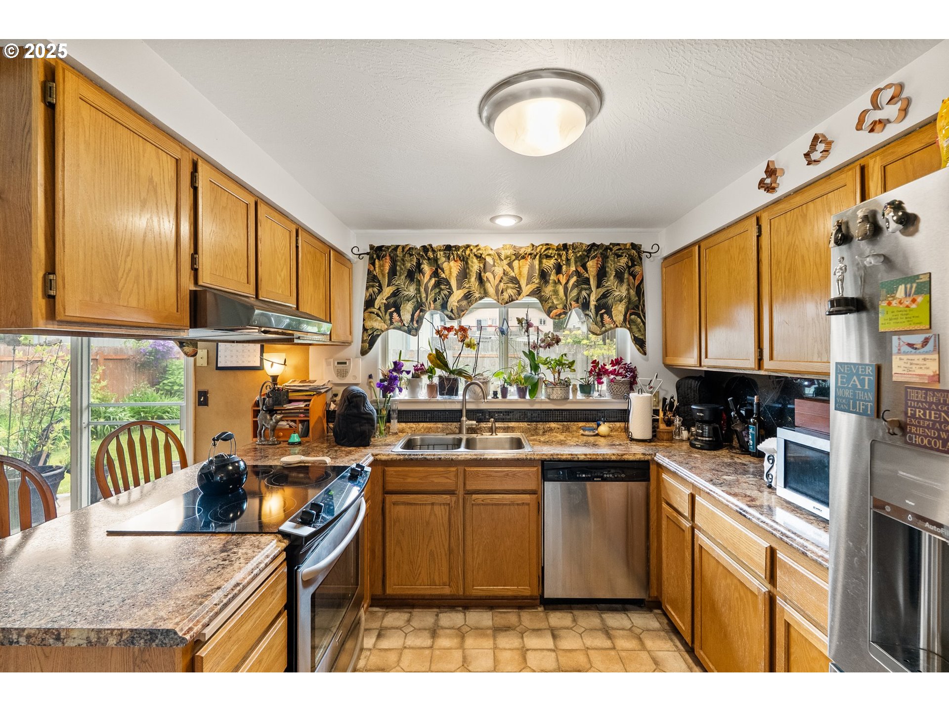 382 South 70th Place Springfield, OR 97478 - Photo 9 of 33 a kitchen with stainless steel appliances granite countertop a stove a sink dishwasher and cabinets with wooden floor