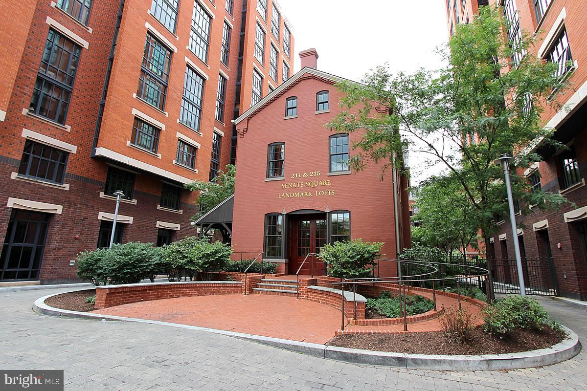 215 I Street Northeast, Unit 111 Washington, DC 20002 - Photo 2 of 34 a view of a white building with plants and entryway