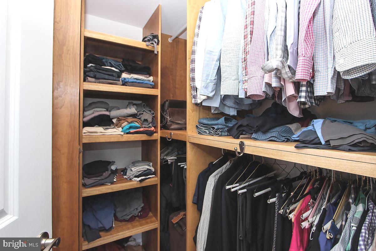 215 I Street Northeast, Unit 111 Washington, DC 20002 - Photo 20 of 34 a view of walk in closet with clothes and shoes