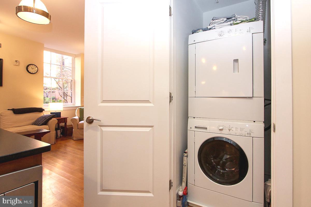 215 I Street Northeast, Unit 111 Washington, DC 20002 - Photo 25 of 34 a view of a hallway with washer and dryer