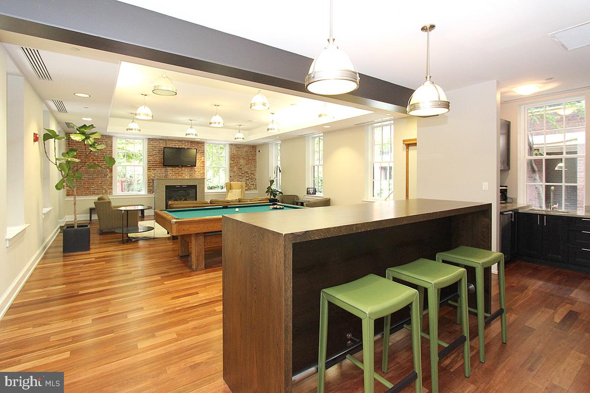215 I Street Northeast, Unit 111 Washington, DC 20002 - Photo 28 of 34 a large kitchen with lots of counter space and dining table