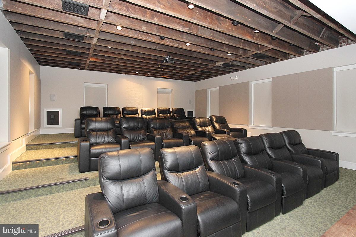 215 I Street Northeast, Unit 111 Washington, DC 20002 - Photo 29 of 34 a media room with lots of chairs and a chandelier