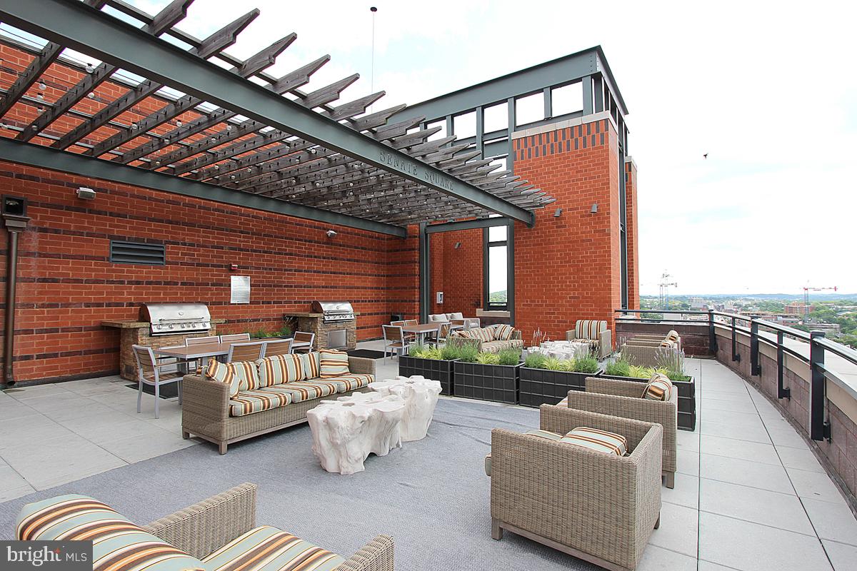 215 I Street Northeast, Unit 111 Washington, DC 20002 - Photo 30 of 34 a balcony with furniture and outdoor seating