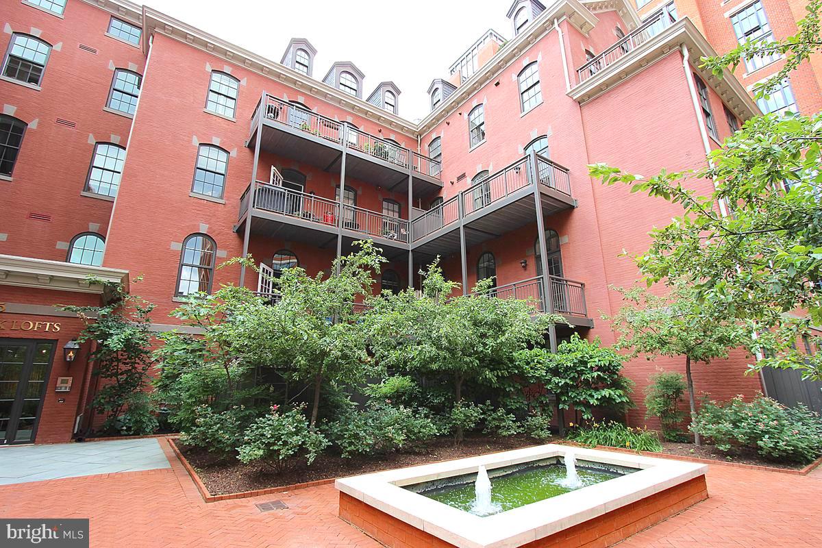 215 I Street Northeast, Unit 111 Washington, DC 20002 - Photo 32 of 34 a view of a building with a yard