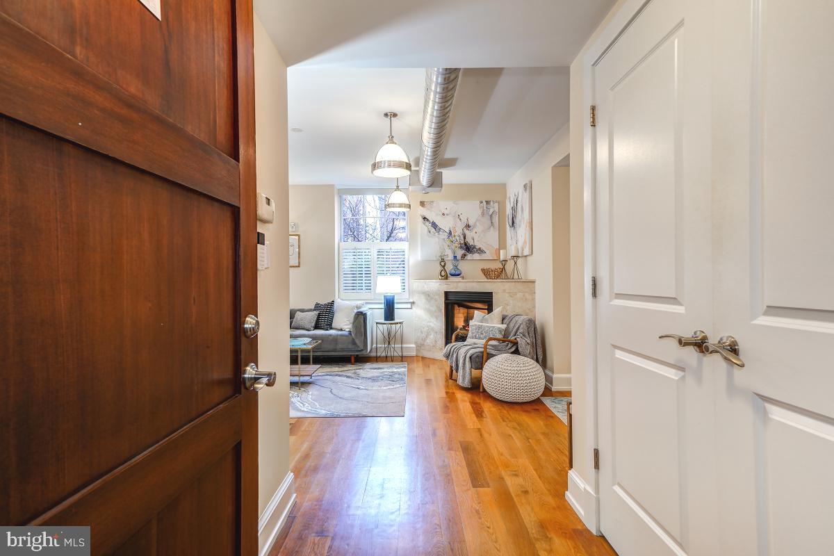 215 I Street Northeast, Unit 111 Washington, DC 20002 - Photo 4 of 34 a view of entryway livingroom and hall with wooden floor