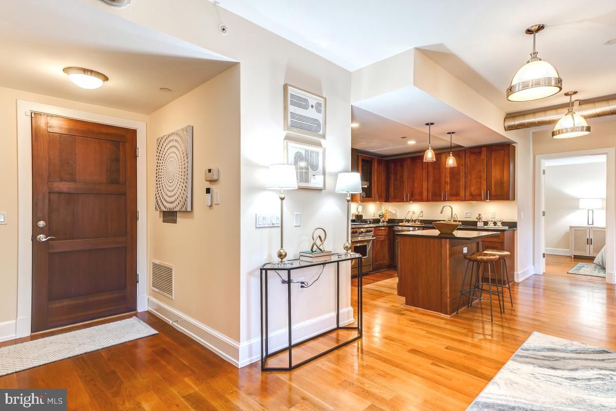 215 I Street Northeast, Unit 111 Washington, DC 20002 - Photo 5 of 34 a kitchen with stainless steel appliances granite countertop a refrigerator a stove and a sink