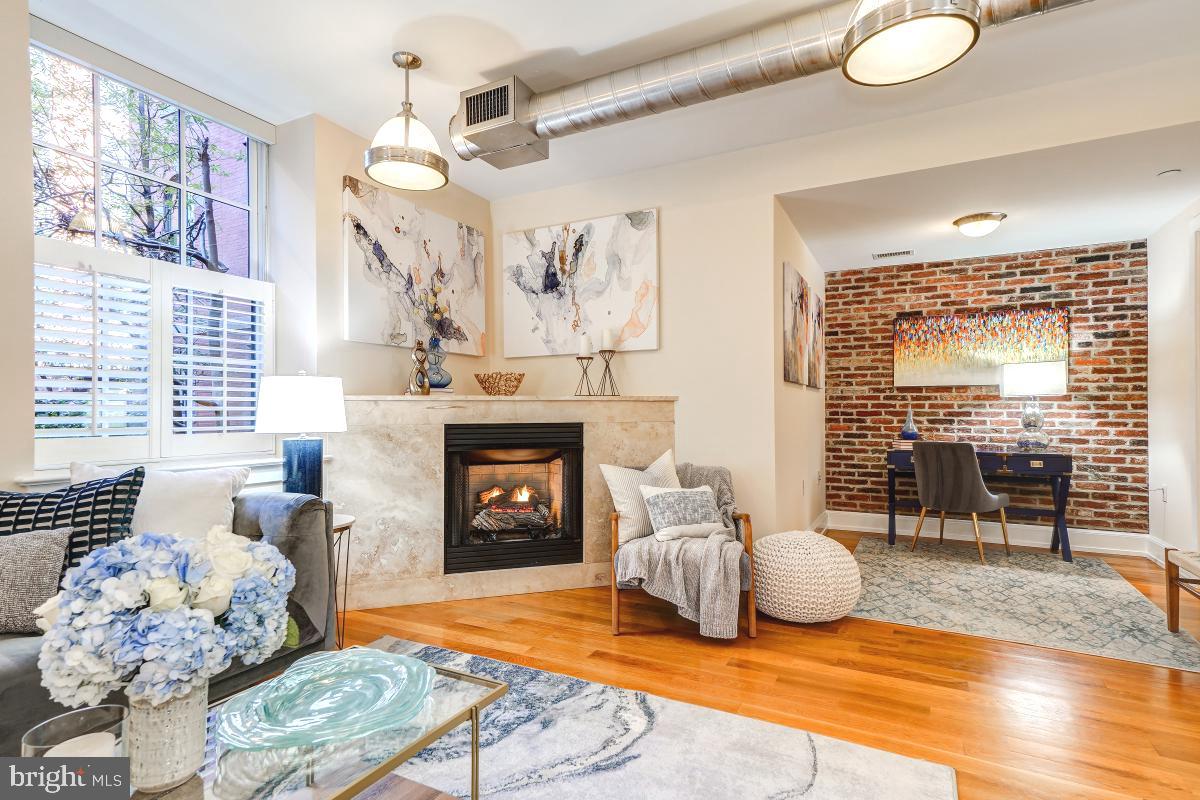 215 I Street Northeast, Unit 111 Washington, DC 20002 - Photo 6 of 34 a living room with furniture and a fireplace