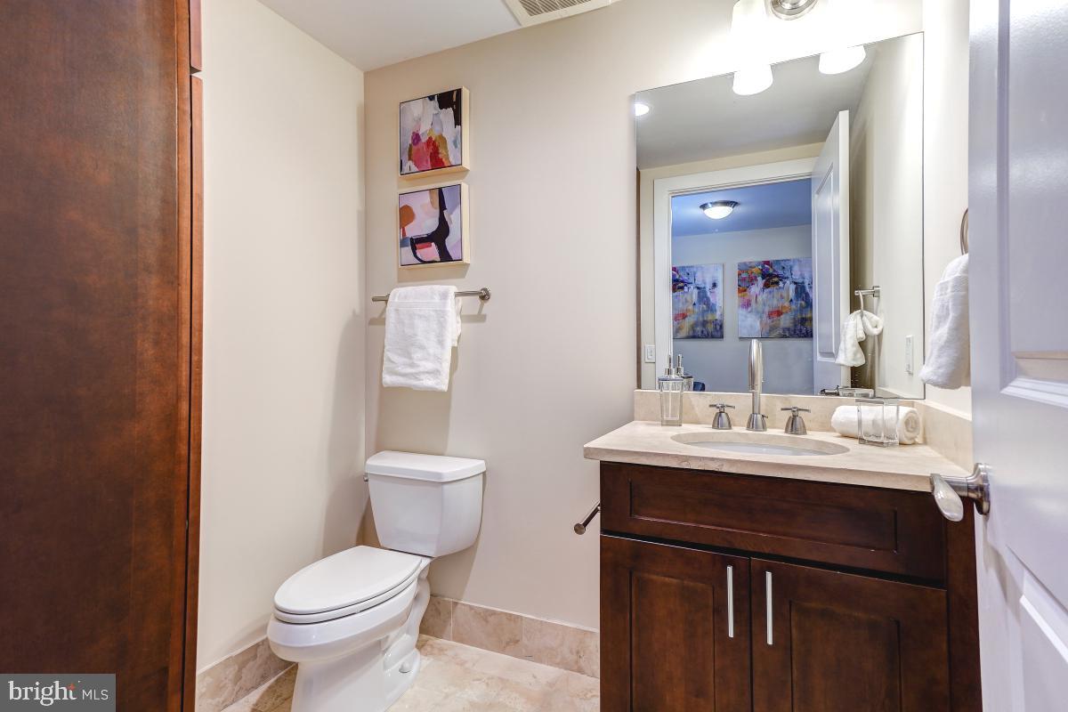 215 I Street Northeast, Unit 111 Washington, DC 20002 - Photo 8 of 34 a bathroom with a toilet sink and mirror